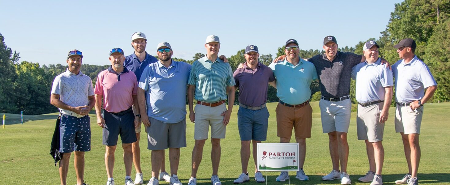 Parton team posing on the golf course